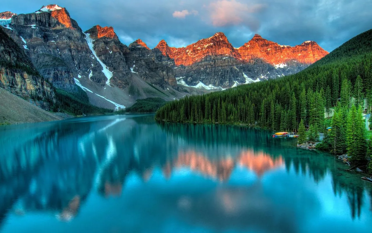 Mountain peaks reflected in an alpine lake at dawn
