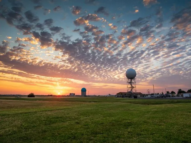 A weather radar tower at sunrise