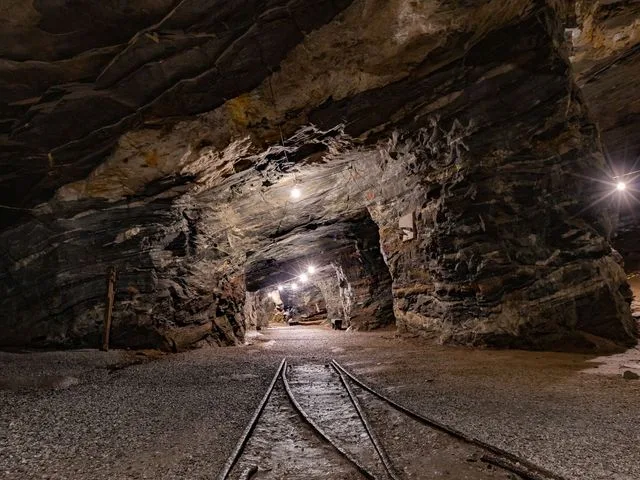 An underground mine drift with rails along its floor